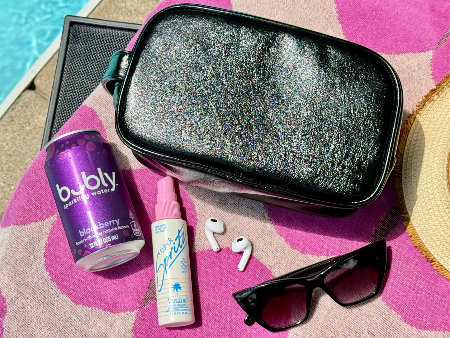 Black Onyx Aurora LED travel makeup organizer packed for a day out with sunglasses, earbuds and sparkling water.