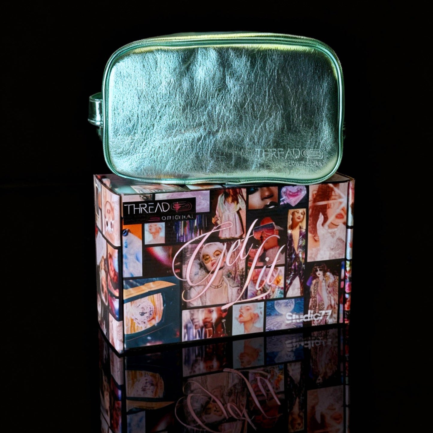 Mint green metallic LED travel makeup bag on collectible Studio 77 gift box. Large vegan leather cosmetic organizer with rechargeable lighting, wipeable insulated lining, and removeable mesh pouches by Thread Original.