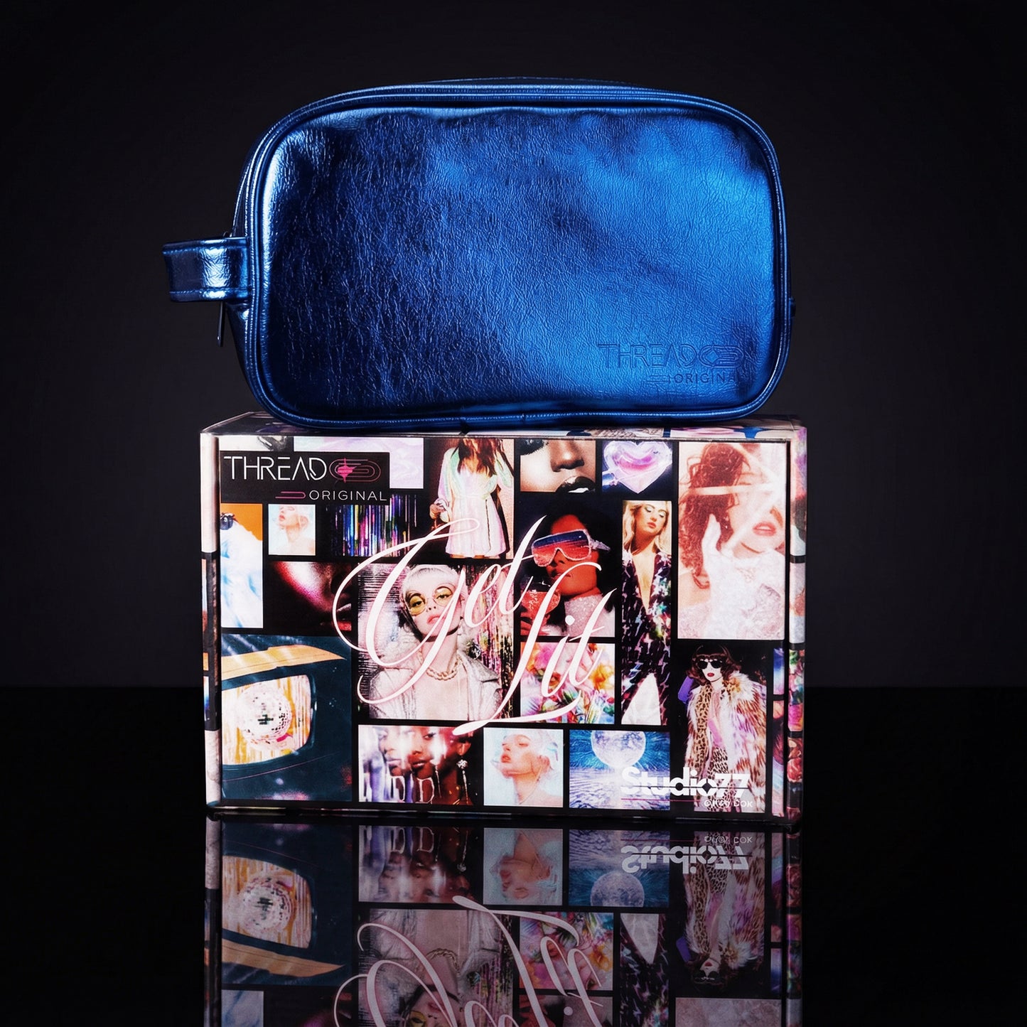 Ocean blue metallic LED travel makeup bag on collectible Studio 77 gift box. Large vegan leather cosmetic organizer with rechargeable lighting, wipeable insulated lining, and removeable mesh pouches by Thread Original.