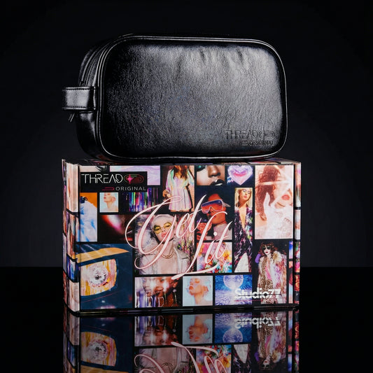 Onyx black metallic LED travel makeup bag on collectible Studio 77 gift box. Large vegan leather cosmetic organizer with rechargeable lighting, wipeable insulated lining, and removeable mesh pouches by Thread Original.