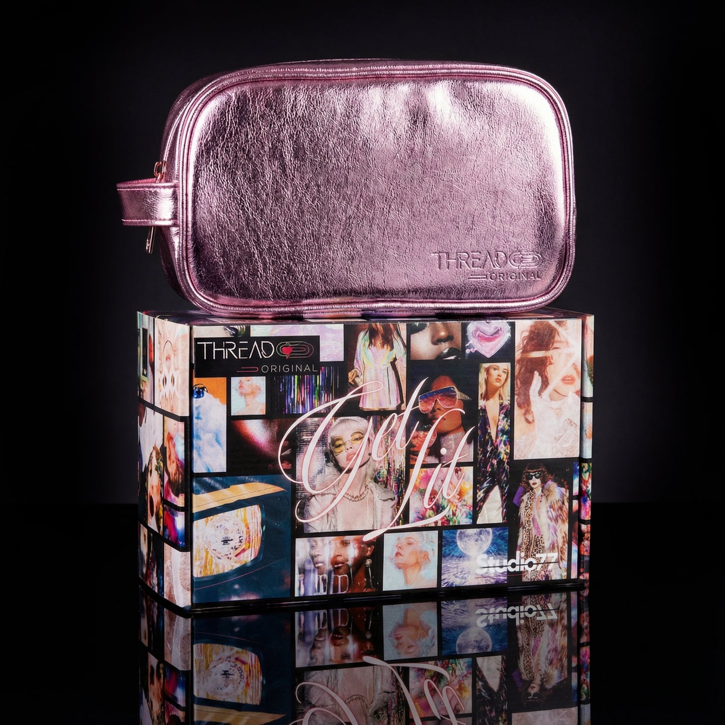 Pink metallic LED travel makeup bag on collectible Studio 77 gift box. Large vegan leather cosmetic organizer with rechargeable lighting, wipeable insulated lining, and removeable mesh pouches by Thread Original.