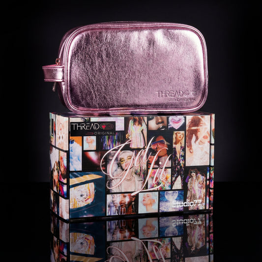Pink metallic LED travel makeup bag on collectible Studio 77 gift box. Large vegan leather cosmetic organizer with rechargeable lighting, wipeable insulated lining, and removeable mesh pouches by Thread Original.