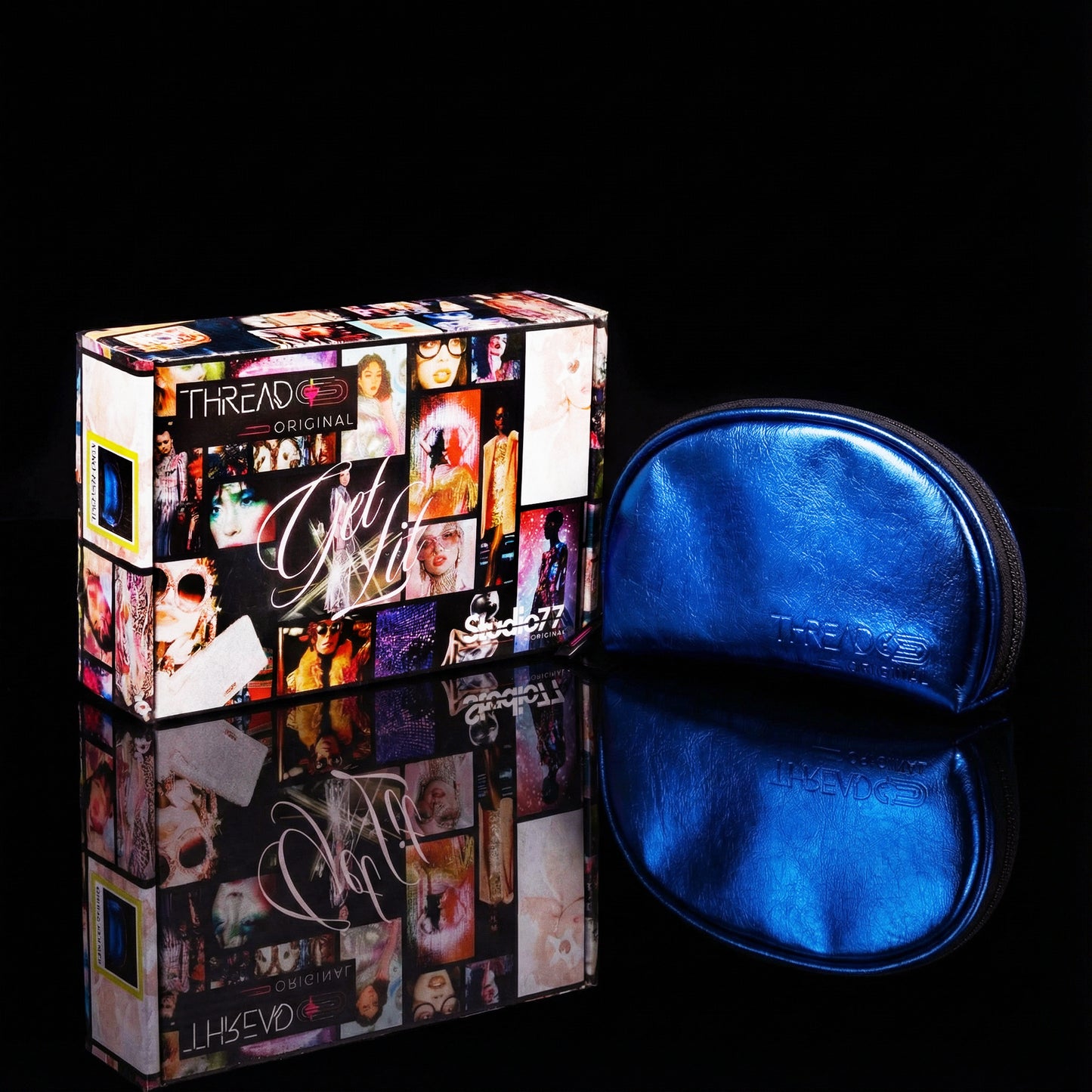 Ocean blue metallic makeup bag with wipeable insulated lining beside Studio 77 collector gift box. Compact vegan leather cosmetic pouch by Thread Original.