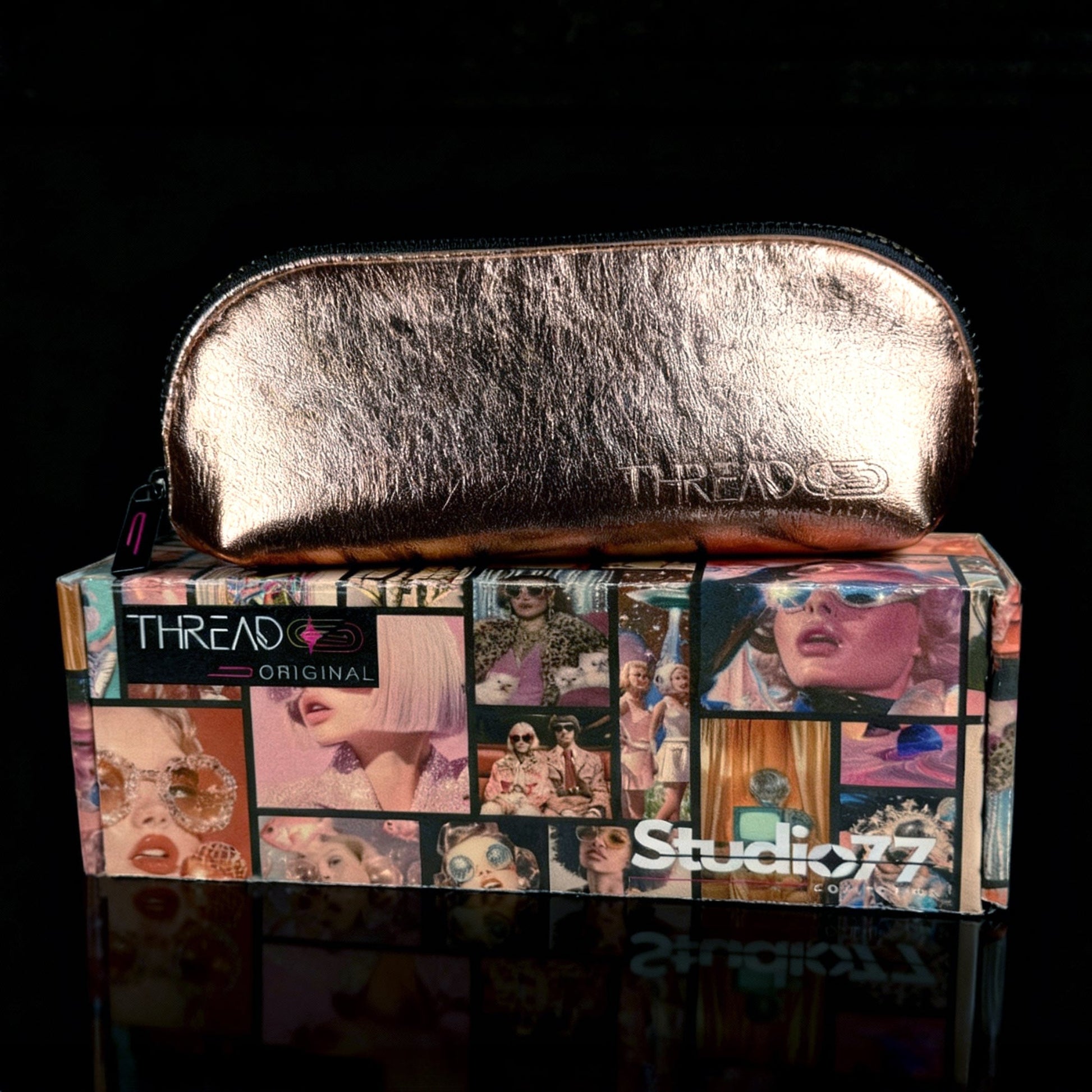 Champagne metallic compact makeup bag on collectible Studio 77 gift box. Slim vegan leather cosmetic pouch with wipeable insulated lining by Thread Original.